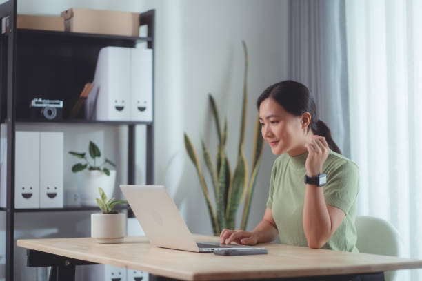 istock Asian woman enjoy with working online using laptop sitting at home office. 1494460251