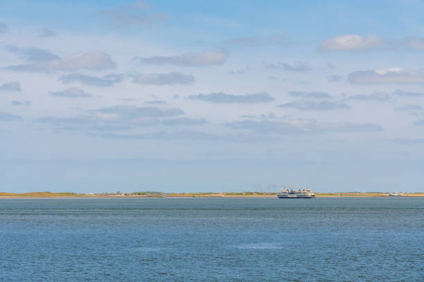 On a sunny day, this ferry boat arrives at sea
