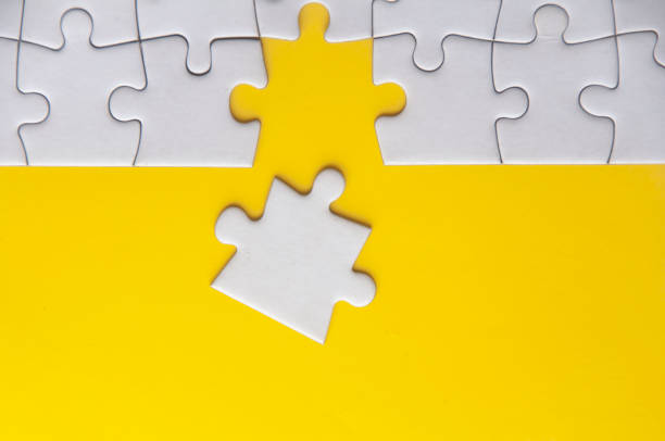 istock Top view of separated jigsaw puzzle with customizable space for text. Copy space with yellow background 1494463631