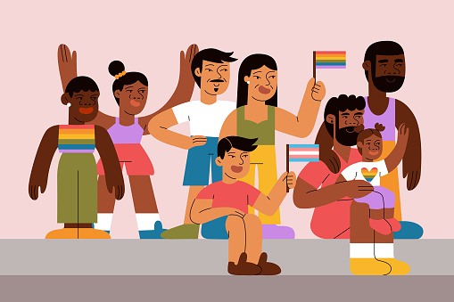 A multiracial group of people watch and celebrate pride parade with flags