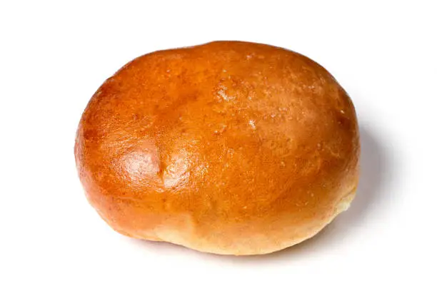 Round sweet bun on a white background. Bakery product close-up.