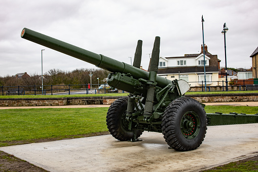 Normandy, France, September 02, 2019: Looking at a 150mm canon of the Longues-sur-Mer artillery battery wich was constructed during the World War II by germans army near the french village of Longues-sur-Mer. The battery was sited on a 60 m (200 ft) cliff overlooking the north sea and formed a part of Germany's Atlantic Wall coastal fortifications. But it couldn´t prevent the Allied landing beaches of Gold and Omaha and shelled both beaches on D-Day (6 June 1944).