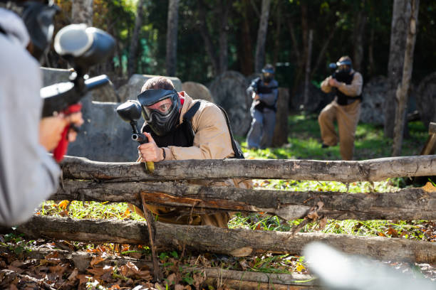 istock Paintball players shooting with guns 1494474904
