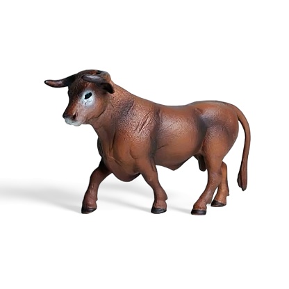 Miniature toy brown bull on a white background