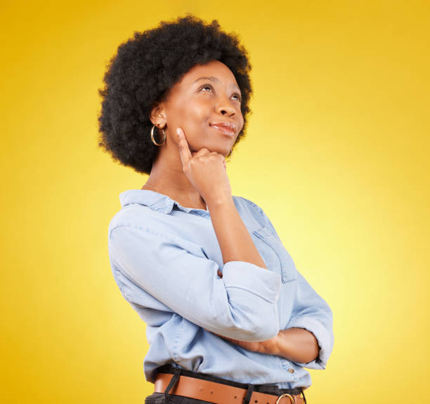 istock Black woman, thinking face and smile in studio with idea or memory on yellow background. African female think of space with afro hair, beauty and happiness for motivation and mindset for planning 1494479120