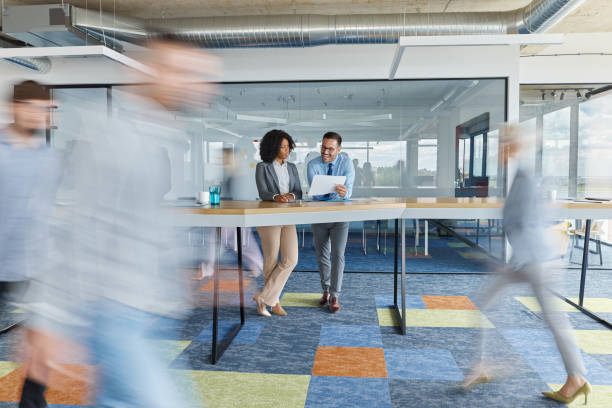 istock Young business people working on reports among colleagues in blurred motion. 1494479295
