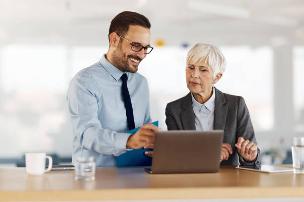 istock Happy entrepreneurs working on laptop in the office. 1494479383
