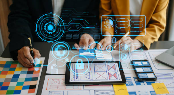 istock Close up view of UI developer team brainstorming on their project with laptop, smartphone and digital tablet. Creative digital development agency. with virtual icons 1494480315