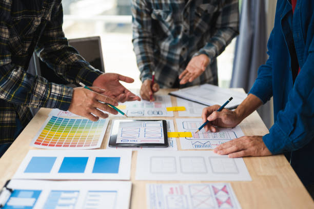 istock Close up view of UI developer team brainstorming on their project with laptop, smartphone and digital tablet. Creative digital development agency. 1494480325