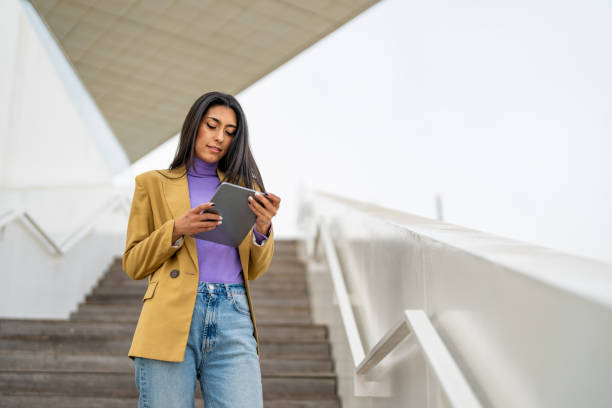 Female university student holding a small tablet