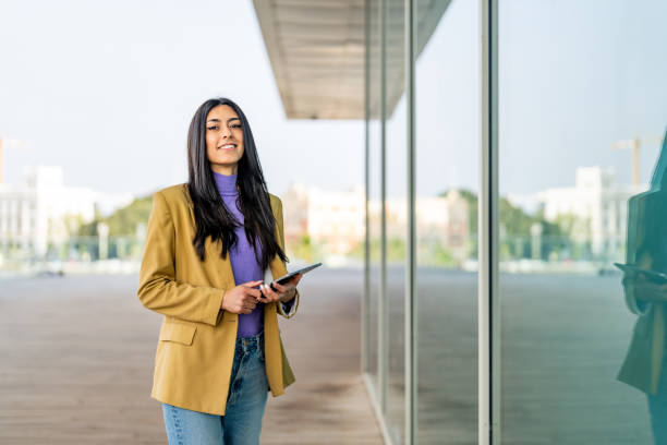 istock Cheerful businesswoman holding digital tablet and looking at camera. 1494483784