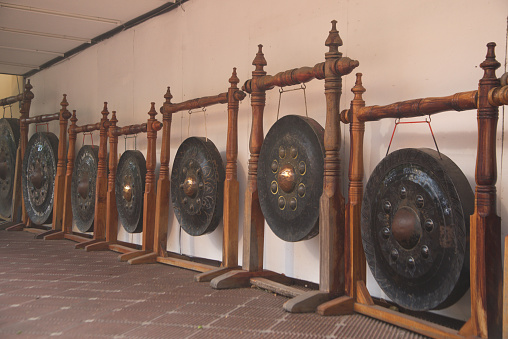 A group of gongs that are decorated at Wat Phra Pathom Chedi for people to hit for religious and good luck. Located at Nakhon Pathom Province in Thailand.