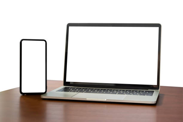 istock Blank screen notebook, laptop and mobile phone on isolated wooden table background with clipping path. Front view. 1494488373