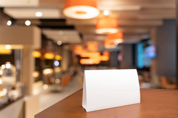 istock Blank menu frame label mockup in restaurant bar stand for booklet with acrylic white sheet paper tent card on wooden table 1494489044