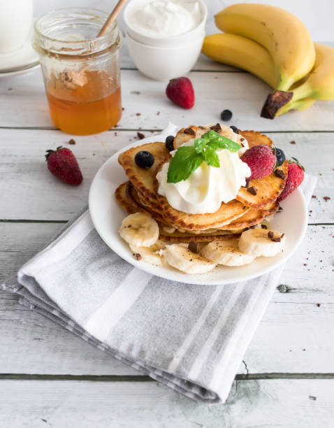 istock Pancakes with fresh berries and cream. Breakfast. On a wooden background 1494489682