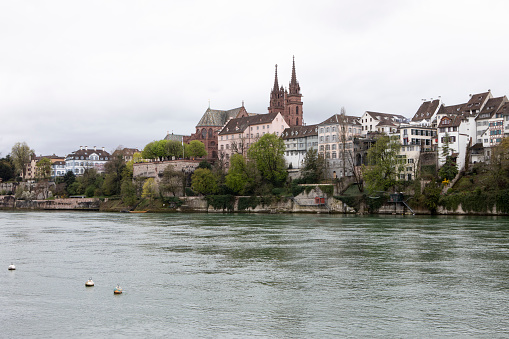 The old town area of Basel, Switzerland, on the west bank of the River Rhine. Photographed from Altstadt Kleinbasel. Basel Minster can be seen on the horizon.
