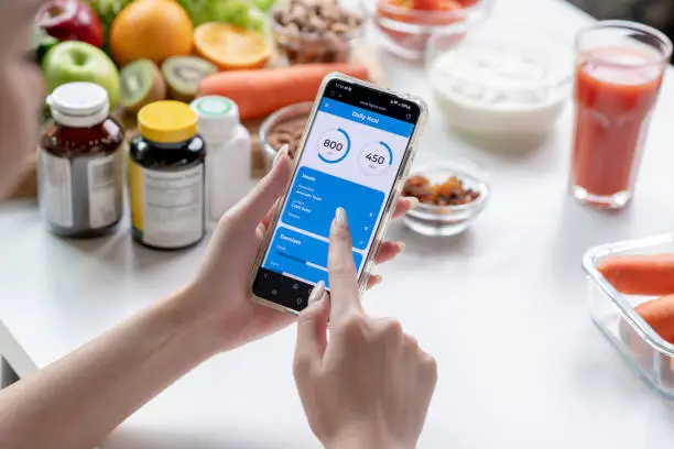 Photo of Nutritionist working and checking data from a smartphone