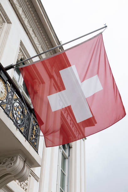 istock Swiss flag outside a traditional building 1494493241