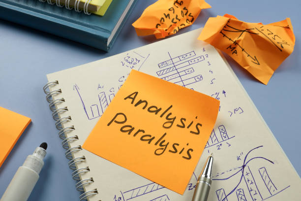 istock Analysis paralysis concept. Notepad with graphs and a sticker with the inscription. 1494493797