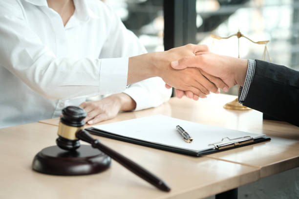 istock Lawyer handshake with client. Business partnership meeting successful concept. 1494494358
