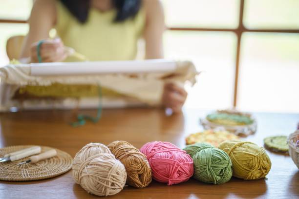 istock Punch needle. Asian Woman making handmade Hobby knitting in studio workshop. designer workplace Handmade craft project DIY embroidery concept. 1494495208