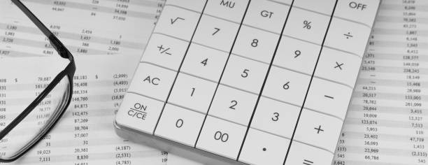 istock Calculator and eye glasses on financial documents. Top view. 1494495288