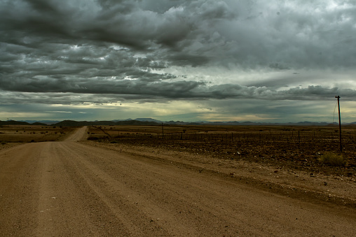Driving along the C28 road on the way back to Karibib in Namibia with stormy skies