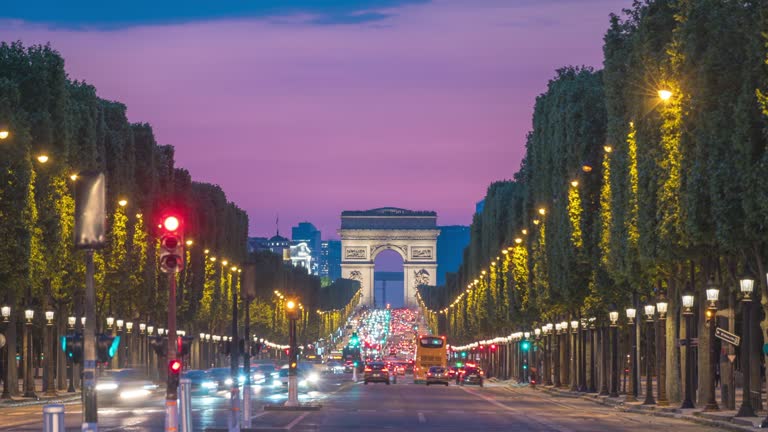 Paris France time lapse 4K, city skyline day to night sunset timelapse at Arc de Triomphe and Champs Elysees street