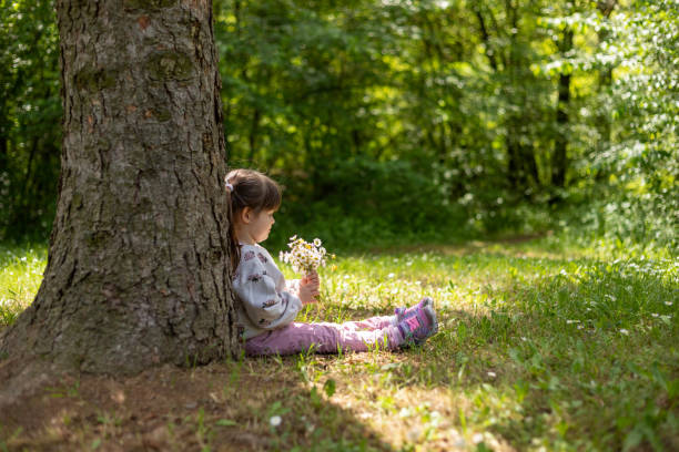 istock Tree, nature, daisies and a little girl. 1494498965
