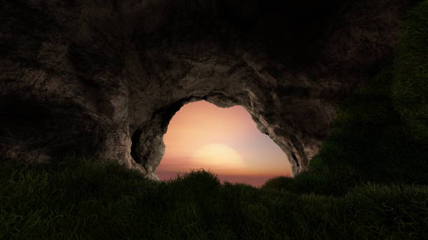istock View from deep cave with grass, hole in rocky mountain, sunset. 3d render 1494500475