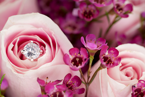 Close up of Pink roses with faux diamond accent and filler flower wedding bouquet