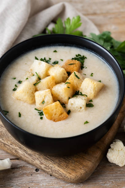istock Cauliflower soup in a bowl on wooden table 1494502699