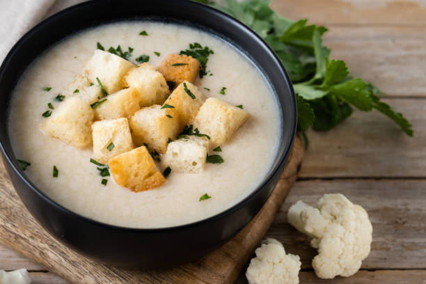 istock Cauliflower soup in a bowl on wooden table 1494502711