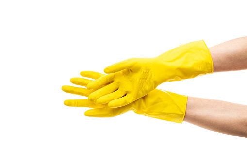 Hands up yellow rubber cleaning gloves isolated on white background. Place for text. Professional cleaning concept. High quality photo