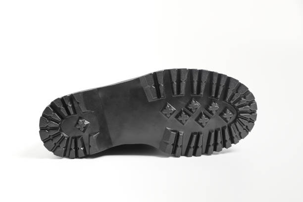 istock Lug sole of black combat boots on high heel platform lying on isolated white background 1494504582