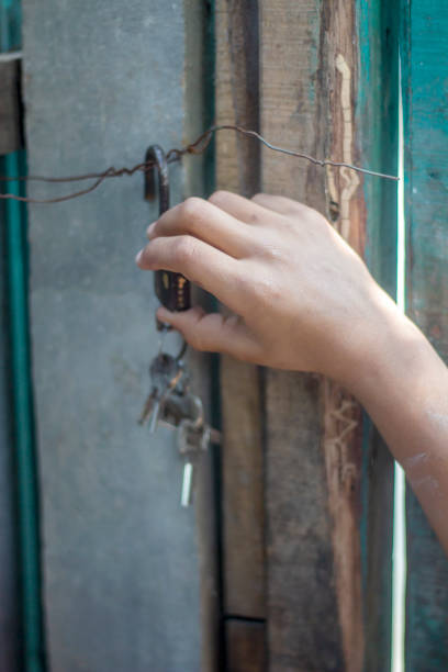 istock A boy is holding an old lock with his hands 1494505409