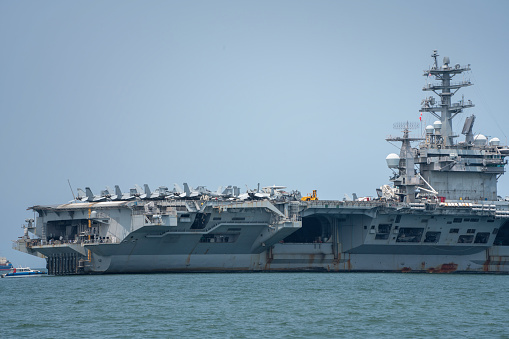 Navy aircraft carrier angled view, with a large compartment of aircraft and crew.