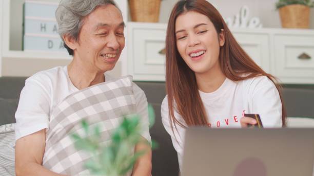 istock Daughter helps father to shopping online. 1494510757