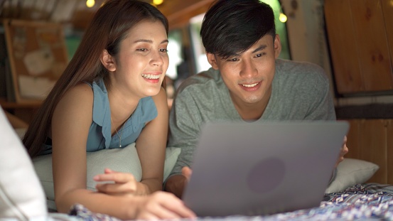 Couple shopping online in a car camp.