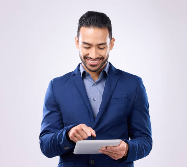 istock Asian man, business and tablet in studio for communication and network connection. Happy male model isolated on a gray background with tech for mobile app, online chat and typing search on internet 1494512806