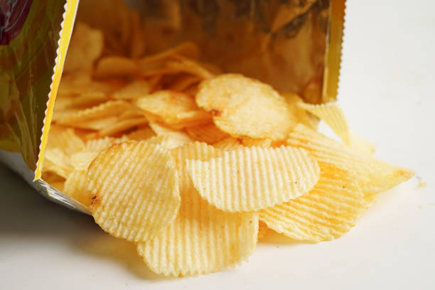 istock Potato chips in open bag, delicious BBQ seasoning spicy for crips, thin slice deep fried snack fast food. 1494512865