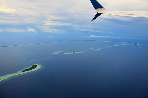 Majuro Atoll, Republic of the Marshall Islands: aerial view of the atoll and lagoon, Kolalen island on the left - aircraft wing and winglet on the frame (croppable).