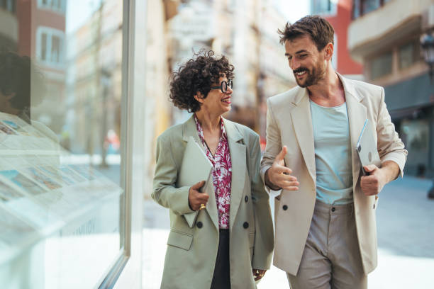 istock Two Business Colleagues Having Discussion Whilst Walking Outside Office. 1494517146