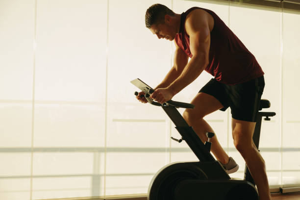 two men doing indoor biking in a fitness club