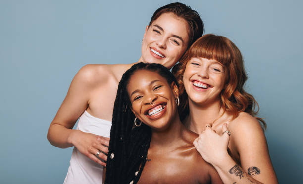 istock Cheerful women with different skin tones smiling at the camera in a studio 1494517790