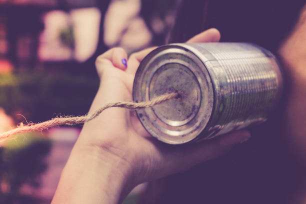 Listening with tin can phone.