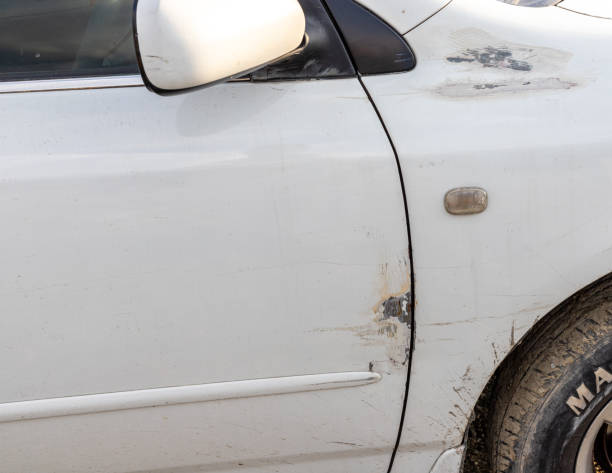 istock Dents on a car door closeup 1494524307