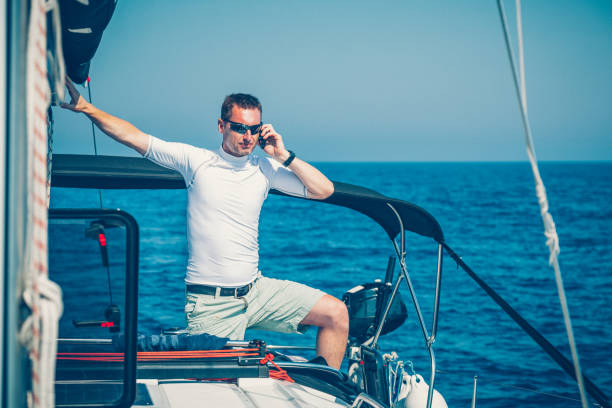 istock Businessman talking on smart phone on sailboat 1494524459