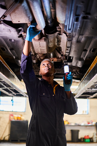 female car mechanic doing vehicle checks