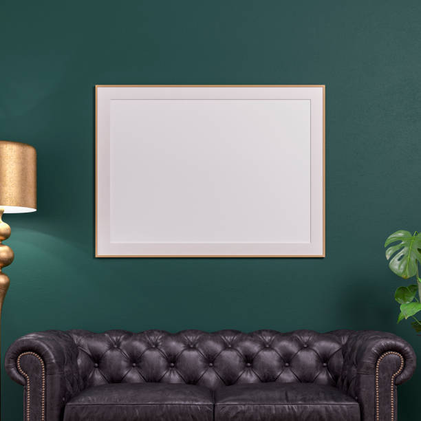 istock Cozy retro-chic interior with a black leather cushion sofa, a large rectangle picture frame and copy space, a retro golden electric lamp and a potted plant, 50s- 60s decoration stock photo 1494525007